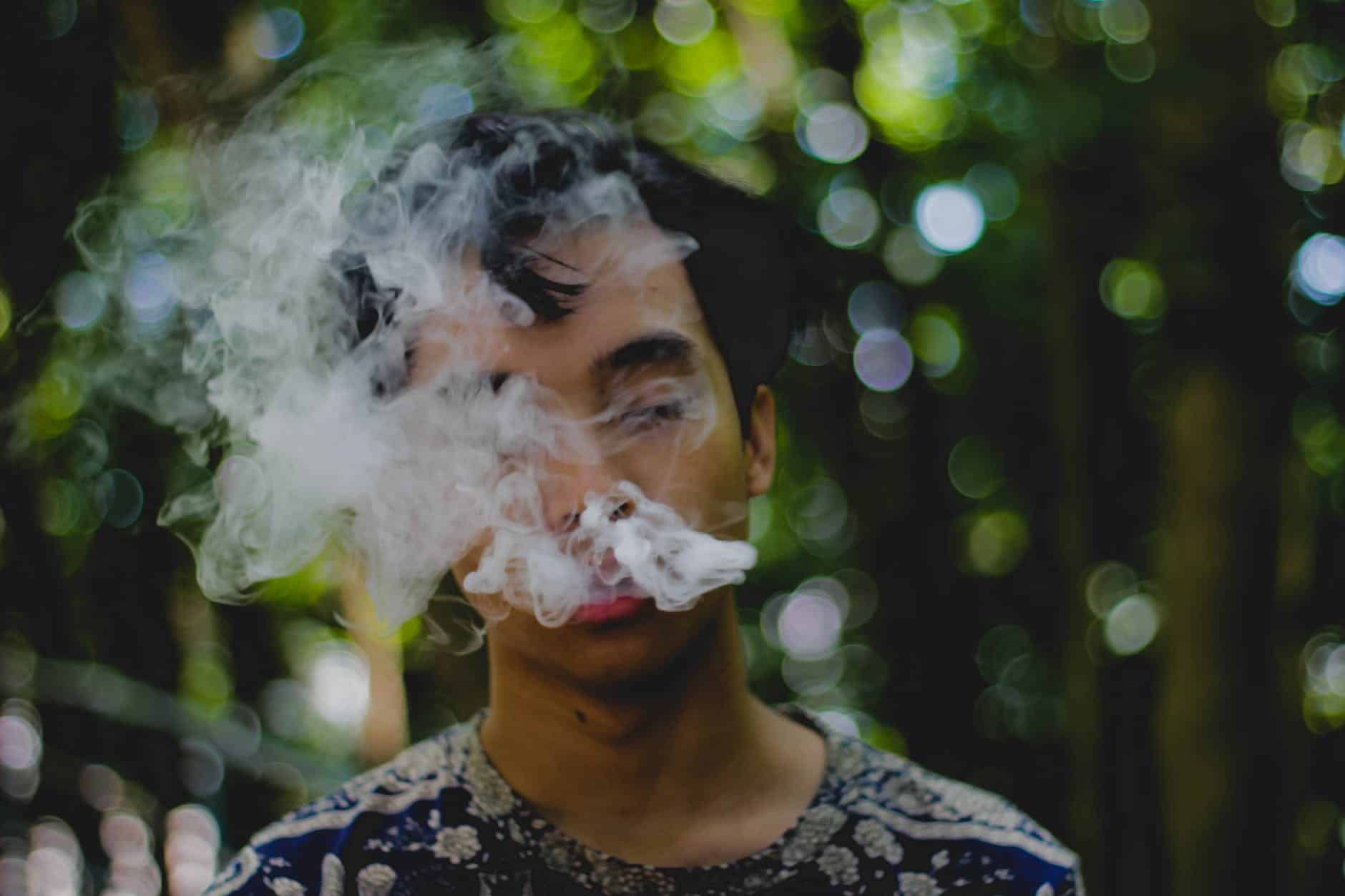 person exhaling smoke